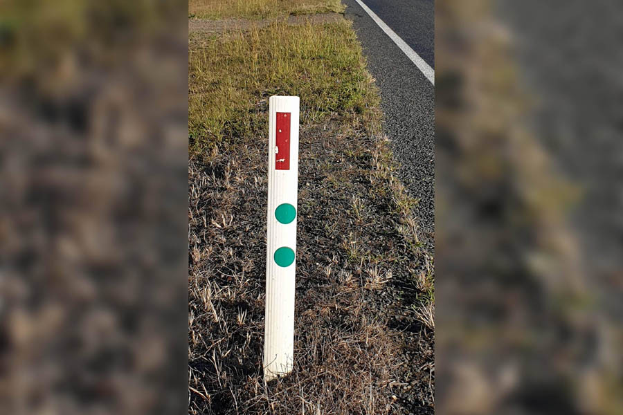 What do the green stickers on road signs mean?
